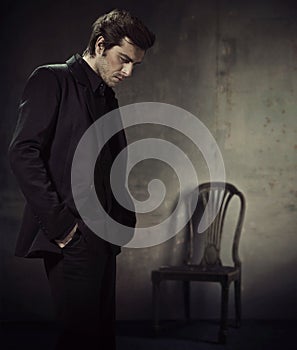 Handsome man in a business suit on a dark background