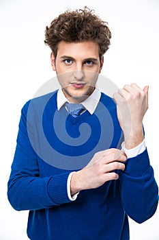 Handsome man buttoning his shirt