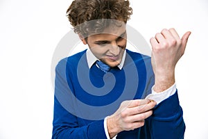 Handsome man buttoning his shirt