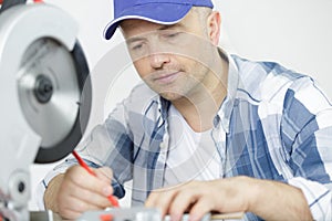 Handsome man carpenter using circular saw