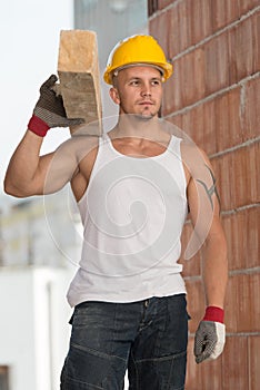 Handsome Man Carrying Wood Planks