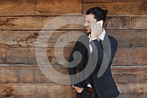 Handsome man cell phone call smile outdoor city street. Young attractive businessman