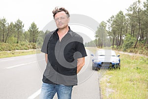 Handsome man with convertible car break down with blue convertible car on road side