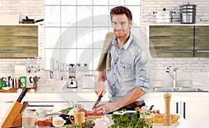 Handsome man cooking in kitchen at home