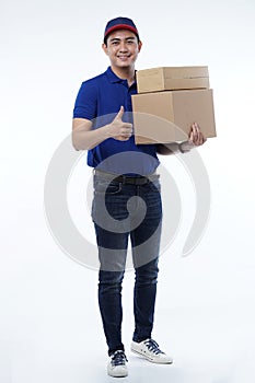 Delivery man in blue uniform with packages isolated on white