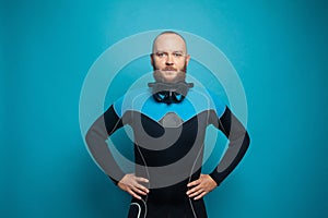 Handsome man diver on blue studio wall background