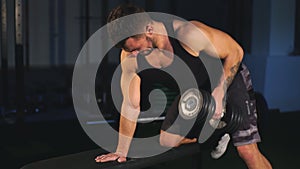 Handsome man doing exercise dumbbells in gym ,Strength and motivation Concept