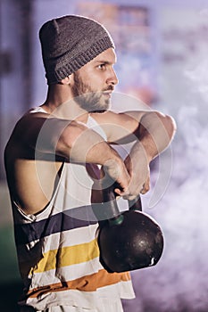 Handsome man doing exercise with dumbbells. photo