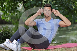 handsome man doing exercise outdoors