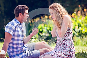 Handsome man doing marriage proposal to his girlfriend