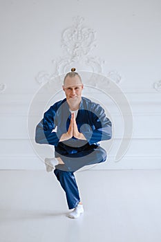 Handsome man doing yoga pose  on a white background