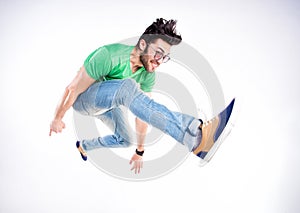 Handsome man dressed casual jumping and smiling - dynamic wide shot