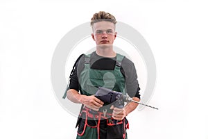 Handsome man with drill machine posing isolated on white. Worker in coverall