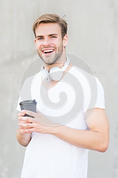 Handsome man drink coffee to go paper cup. Cafe concept. Coffee shop. Peaceful calm guy enjoy fresh hot brewed coffee