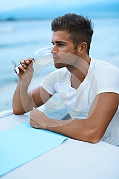 Handsome Man Drinking Glass Wine In Sea Restaurant In Summer