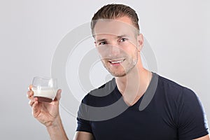 Handsome man drinking milk