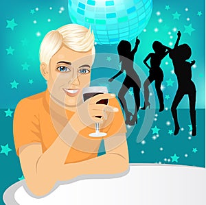 Handsome man drinking wine