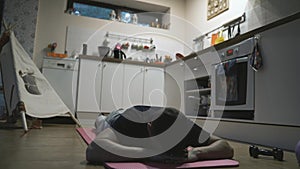 Handsome Man Exercising and Doing Push ups in The Kitchen at Home