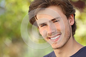 Handsome man face with a white perfect smile photo