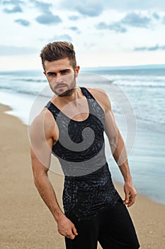 Handsome Man With Fit Muscular Body In Sportswear On Beach.