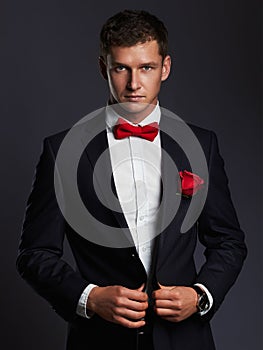 Handsome man with flower. young groom man in suit