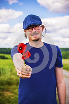 Handsome man is giving flowers as a present.