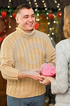 Handsome man giving present to his pretty woman