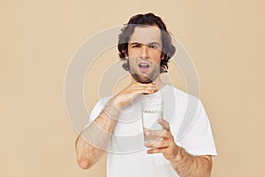 handsome man glass of water in his hands emotions posing isolated background
