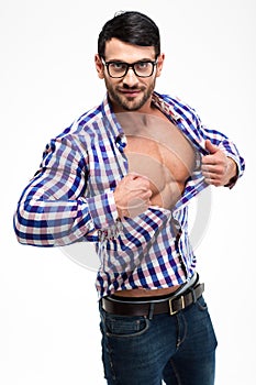 Handsome man in glasses unbuttoning shirt