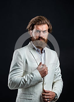 Handsome man on gray background. serious bearded businessman. stylish mature man looking modern. mens office wardrobe