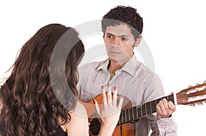 Handsome man with guitar serenading young girl photo