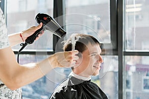 Handsome man at the hairdresser getting a new haircut