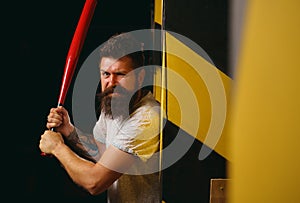 Handsome man hand holds baseball sport bat. Power and energy concept. Bearded man with baseball bat. Gangster with bat