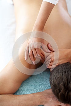 Handsome man having massage in spa salon