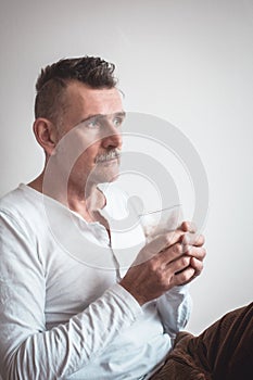 Handsome man in his 50s drinking ccoffee