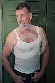 Handsome man in his 50s with white ripped t-shirt