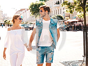 Handsome man and his beautiful girlfriend posing outdoors