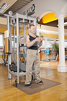 Handsome man in his forties exercising in gym
