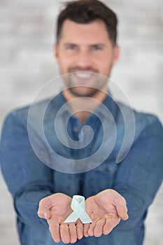 handsome man holding aids sign ribbon