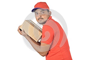 Handsome man holding carton box very tight