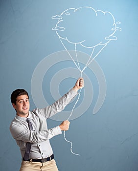 Handsome man holding cloud balloon drawing