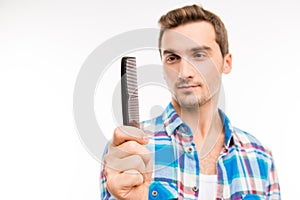 Handsome man holding a comb