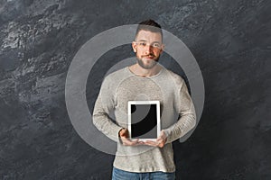 Handsome man holding digital tablet in studio