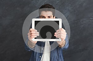 Handsome man holding digital tablet in studio