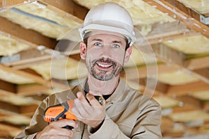 handsome man holding electric drill