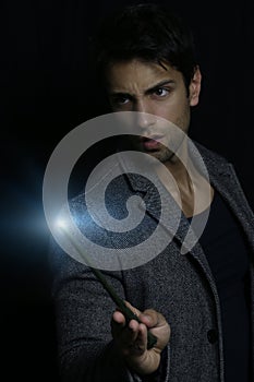 Handsome man holding a magic wand