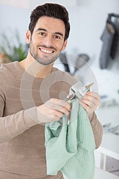 handsome man holding paint brushes