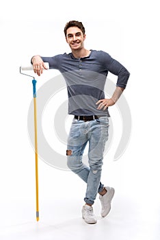 Handsome man holding paint roller isolated on white