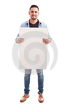 Handsome man holding a sign