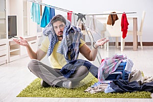 The handsome man husband doing laundering at home